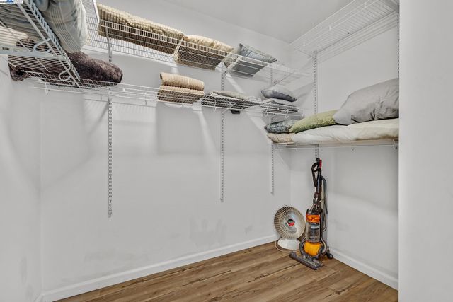 a view of storage and utility room with wooden floor
