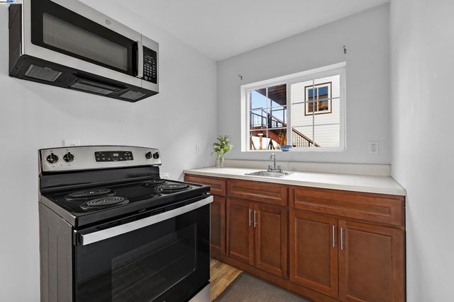 a kitchen with stainless steel appliances a stove and a microwave