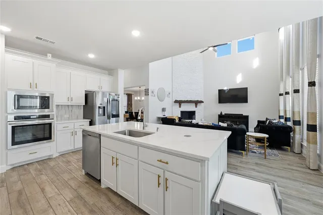 a bathroom with a granite countertop sink a toilet and shower