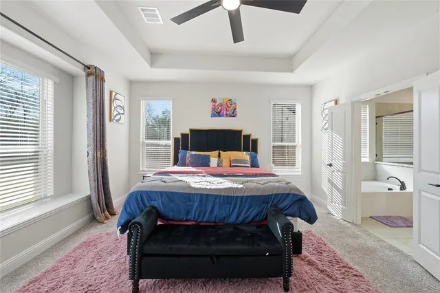 a bedroom with a large bed and a window