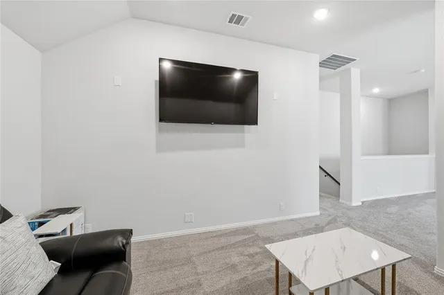 a living room with furniture a ceiling fan and a rug
