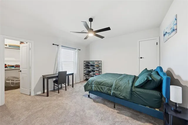 a bedroom with a bed closet and a window