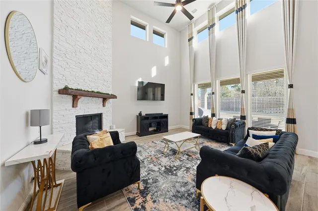 a living room with furniture fireplace and flat screen tv