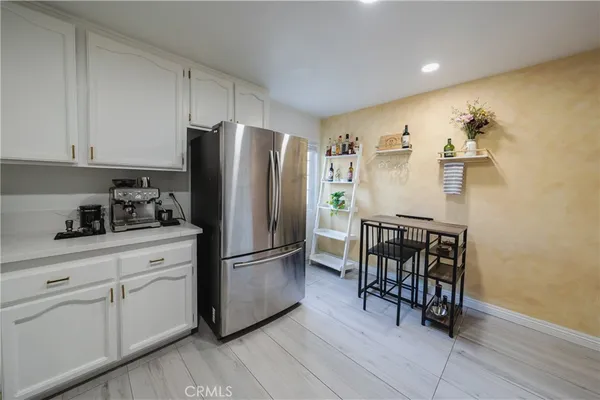 a kitchen with stainless steel appliances granite countertop a refrigerator and a stove top oven