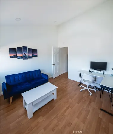 a living room with a couch and a desk