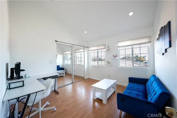 a living room with furniture wooden floor and a window