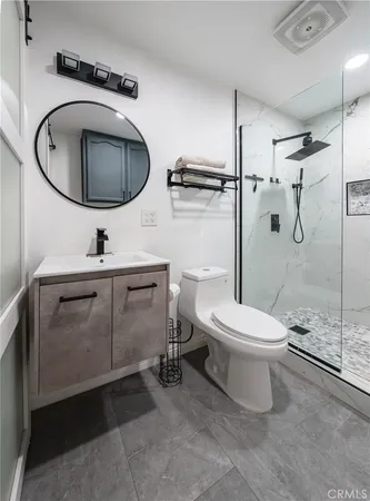 a bathroom with a toilet a sink and a mirror