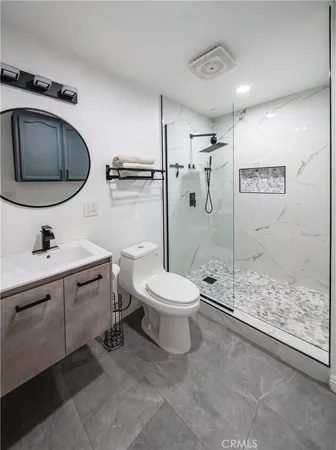 a bathroom with a toilet a sink and shower