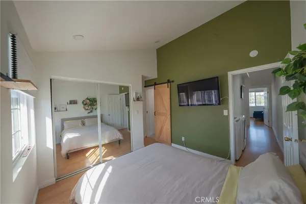 a view of a livingroom with a kitchen and a refrigerator