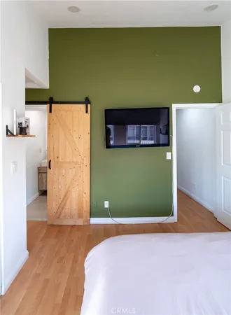 a bed sitting in a bedroom next to a bathroom