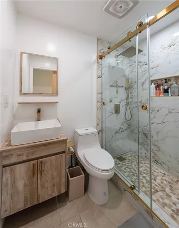 a bathroom with a sink toilet and shower