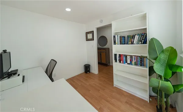 a bedroom with furniture and a book shelf