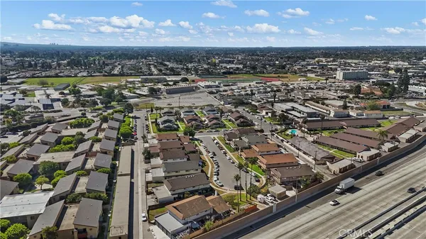 an aerial view of residential houses with city view