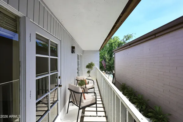a balcony with table and chairs