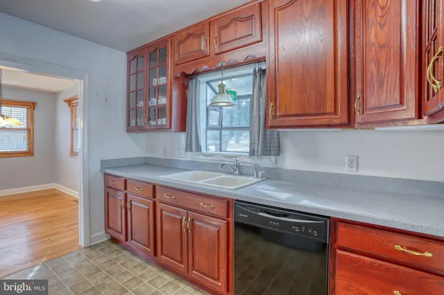 a kitchen with granite countertop stainless steel appliances a sink stove and cabinets