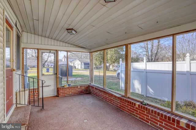 a view of an empty room with windows