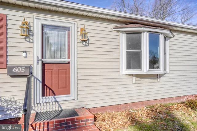 a view of a house with a door and wooden floor