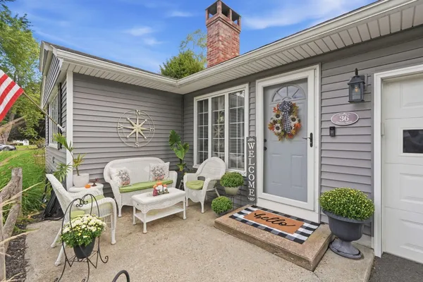 a white bench sitting in front of a house