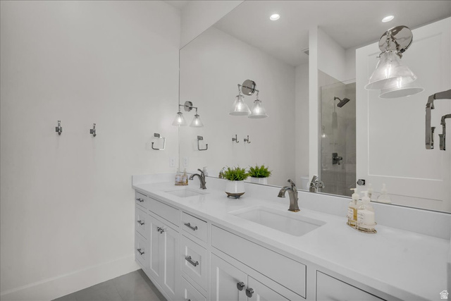 2608 Canyon Ridge Drive St. George, UT 84770 - Photo 72 of 86 Bathroom featuring a dual vanity with white shaker-style cabinetry, a solid surface countertop, and undermount sinks