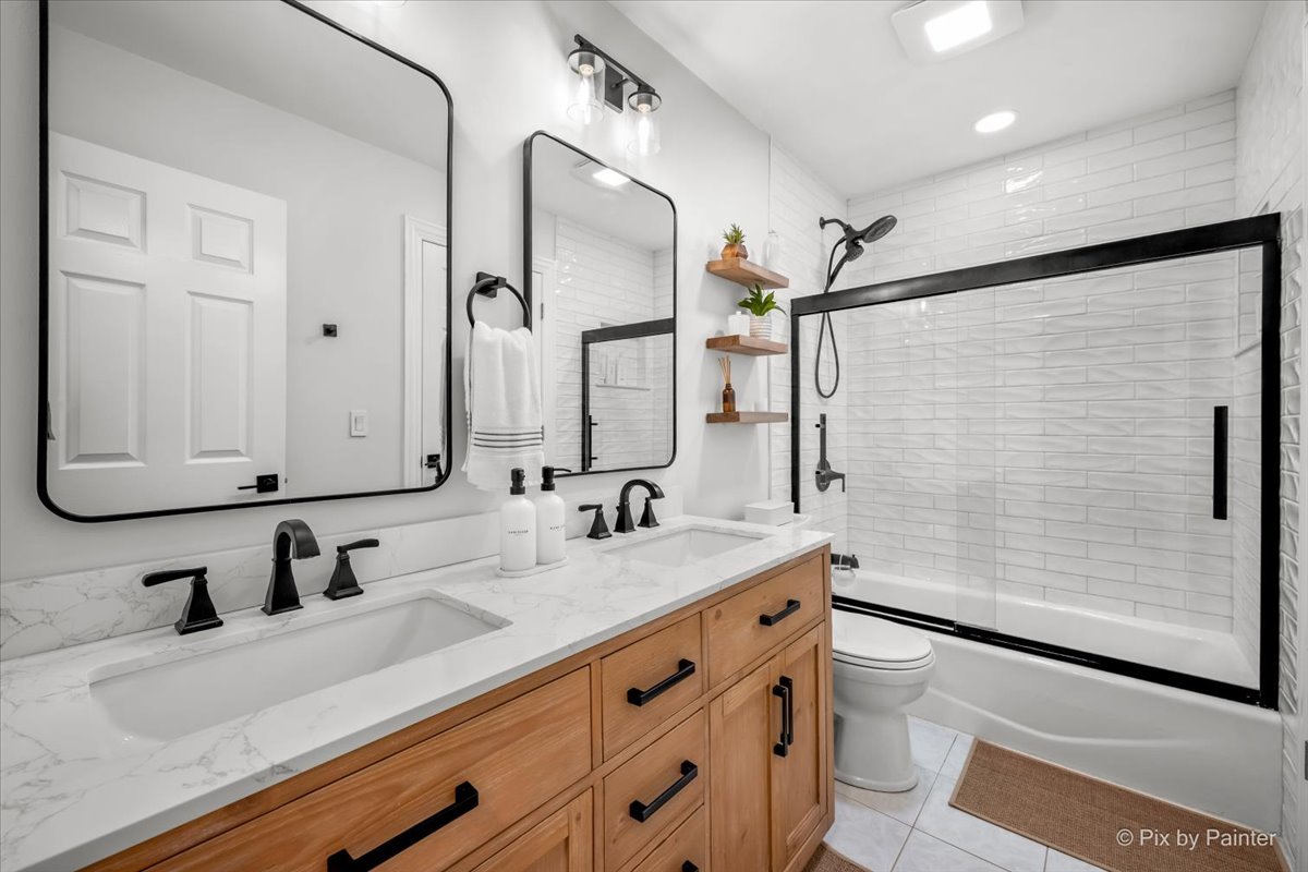 1908 Moore Avenue St. Charles, IL 60174 - Photo 17 of 45 a bathroom with a double vanity sink mirror double and shower