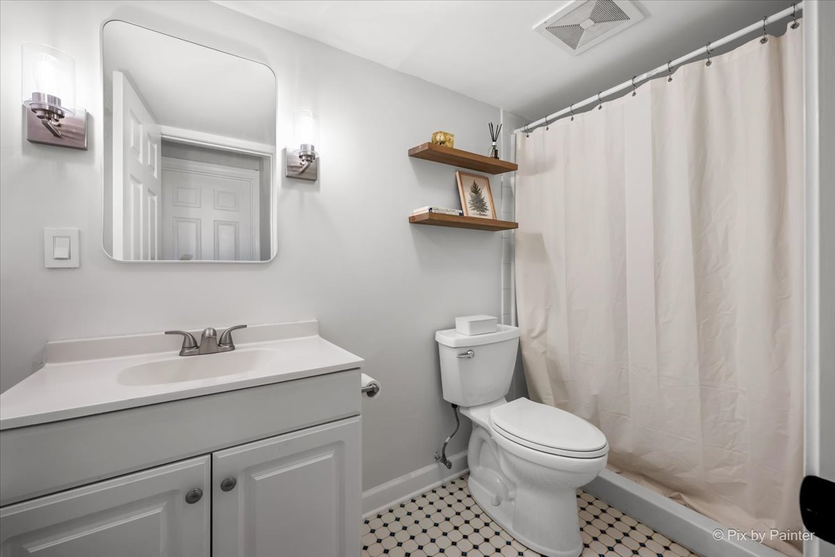 1908 Moore Avenue St. Charles, IL 60174 - Photo 31 of 45 a bathroom with a toilet sink and mirror