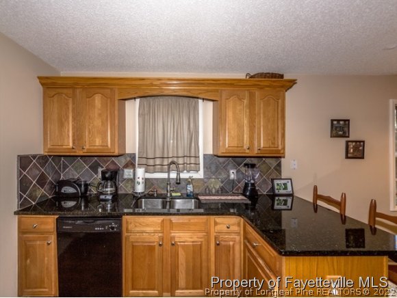 160 Old Hunt Road Pinehurst, NC 28374 - Photo 6 of 21 a kitchen with granite countertop a sink a stove and cabinets