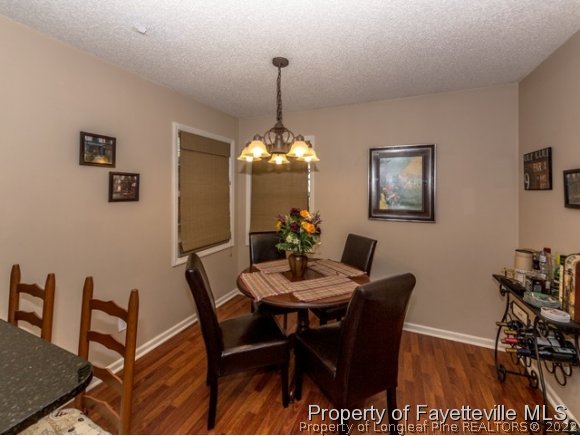 160 Old Hunt Road Pinehurst, NC 28374 - Photo 7 of 21 a dining room with furniture a chandelier and wooden floor