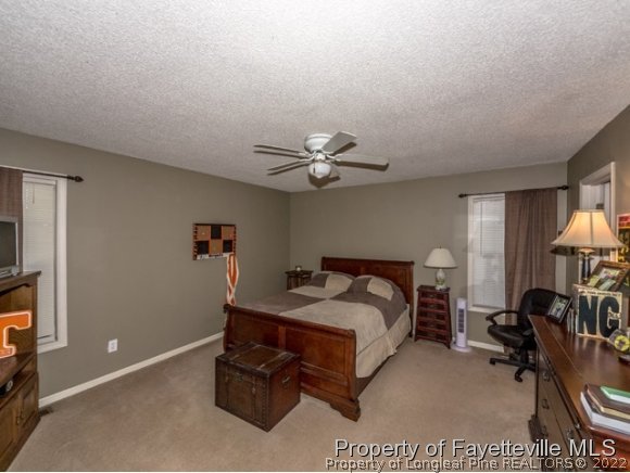 160 Old Hunt Road Pinehurst, NC 28374 - Photo 8 of 21 a bedroom with a bed and a chandelier