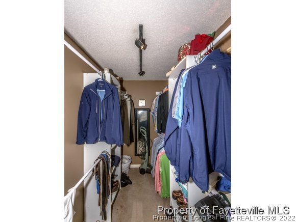 160 Old Hunt Road Pinehurst, NC 28374 - Photo 9 of 21 a view of walk in closet with clothes and shoes
