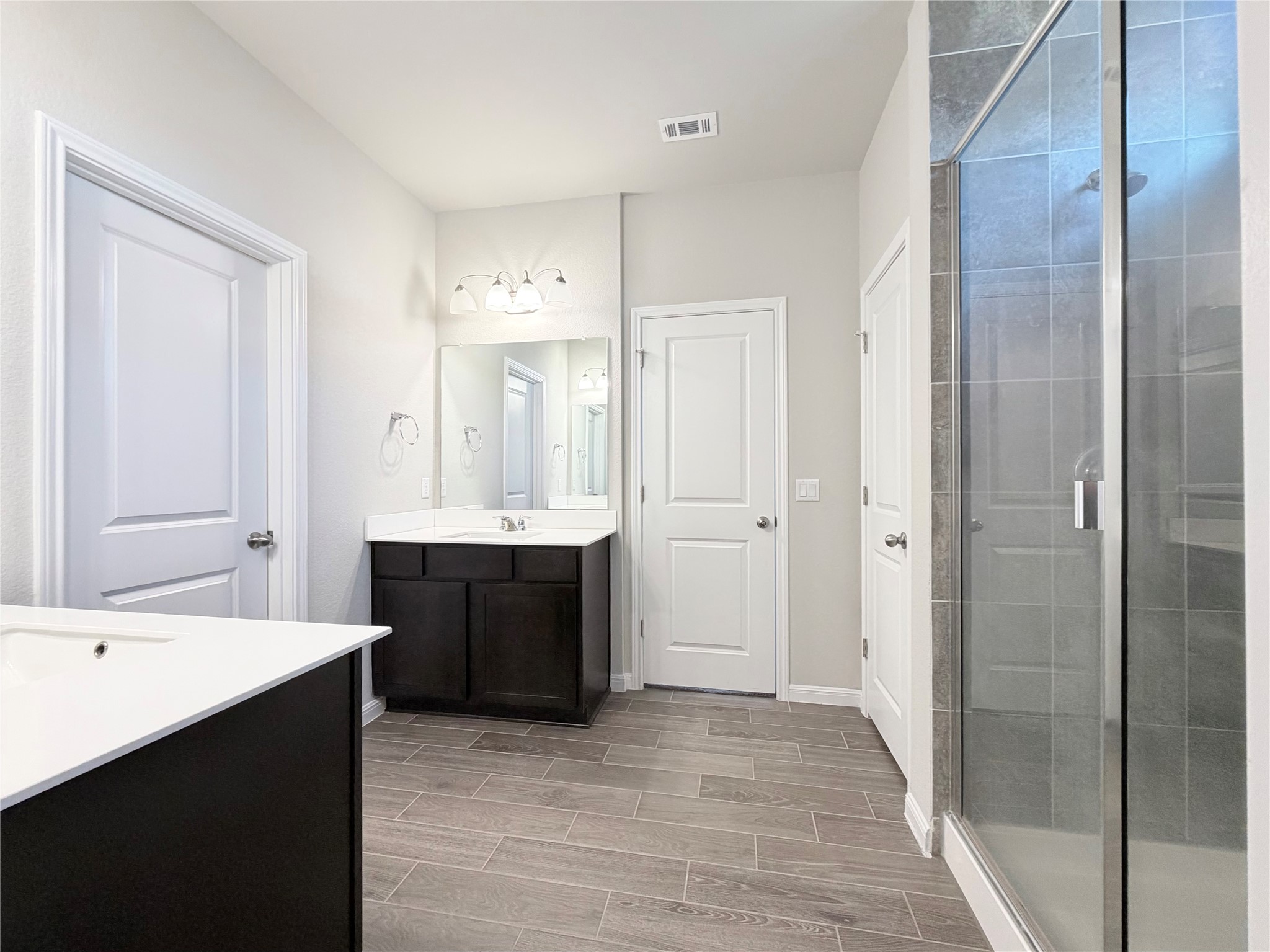 18104 Emu Lane Manor, TX 78653 - Photo 23 of 39 a large bathroom with a double vanity sink mirror and double