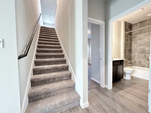 a view of an entryway with wooden floor and a floor to ceiling window