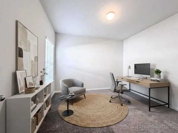 a work room with furniture and a flat screen tv