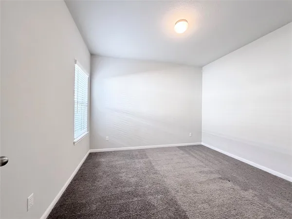 an empty room with a empty space and windows
