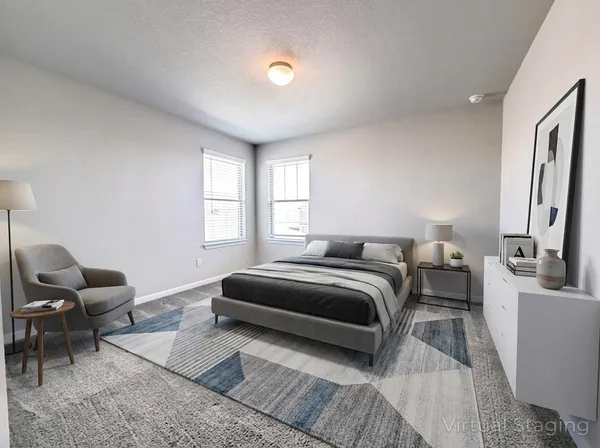 a bedroom with a bed and a couch