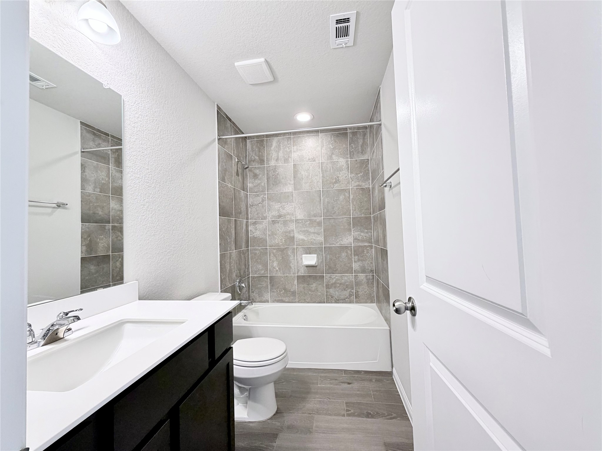 18104 Emu Lane Manor, TX 78653 - Photo 36 of 39 a bathroom with a bathtub shower sink mirror vanity and toilet
