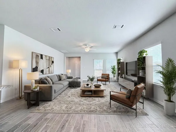 a living room with furniture wooden floor and a flat screen tv