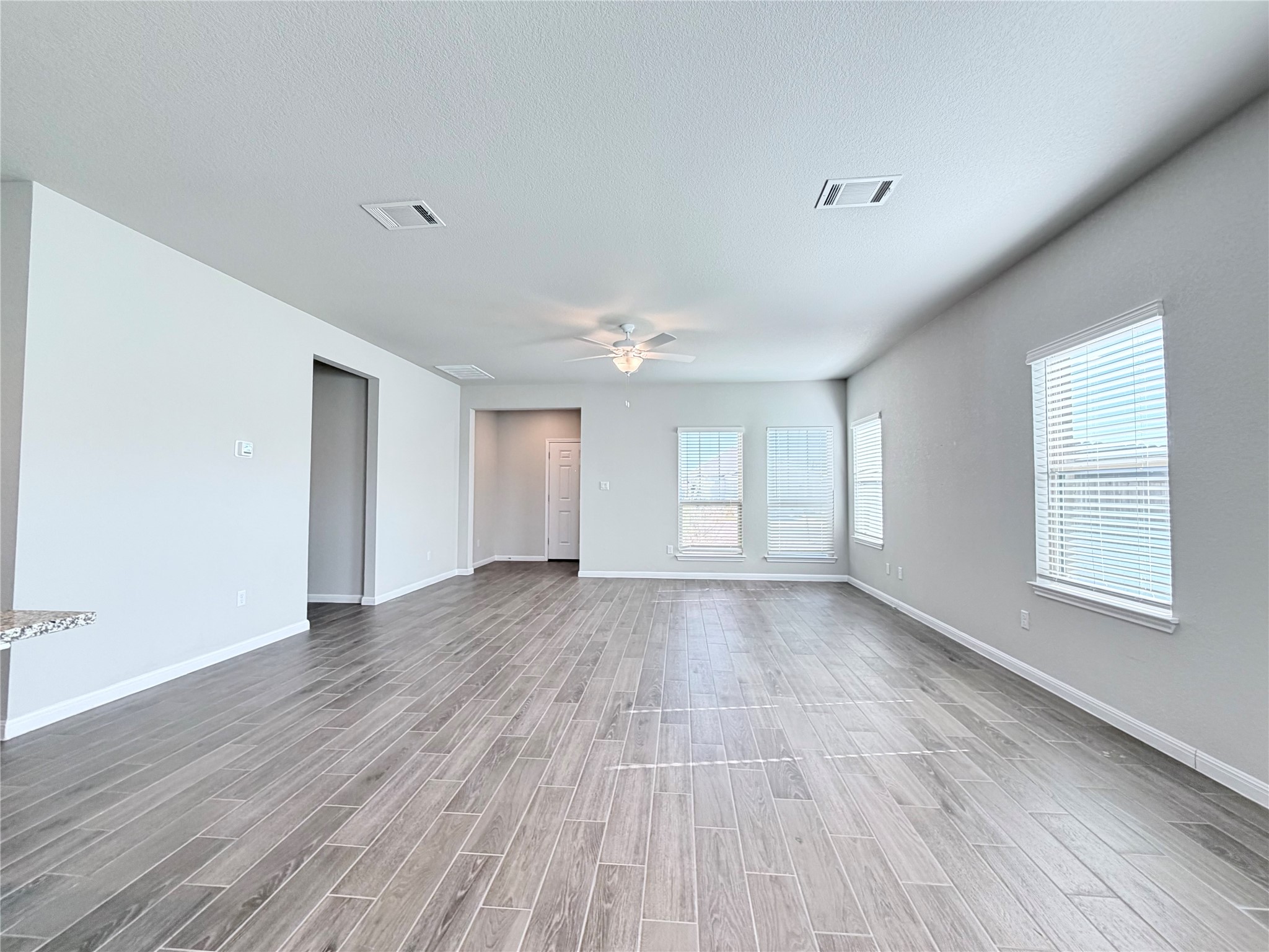 18104 Emu Lane Manor, TX 78653 - Photo 10 of 39 a view of an empty room with wooden floor and a window