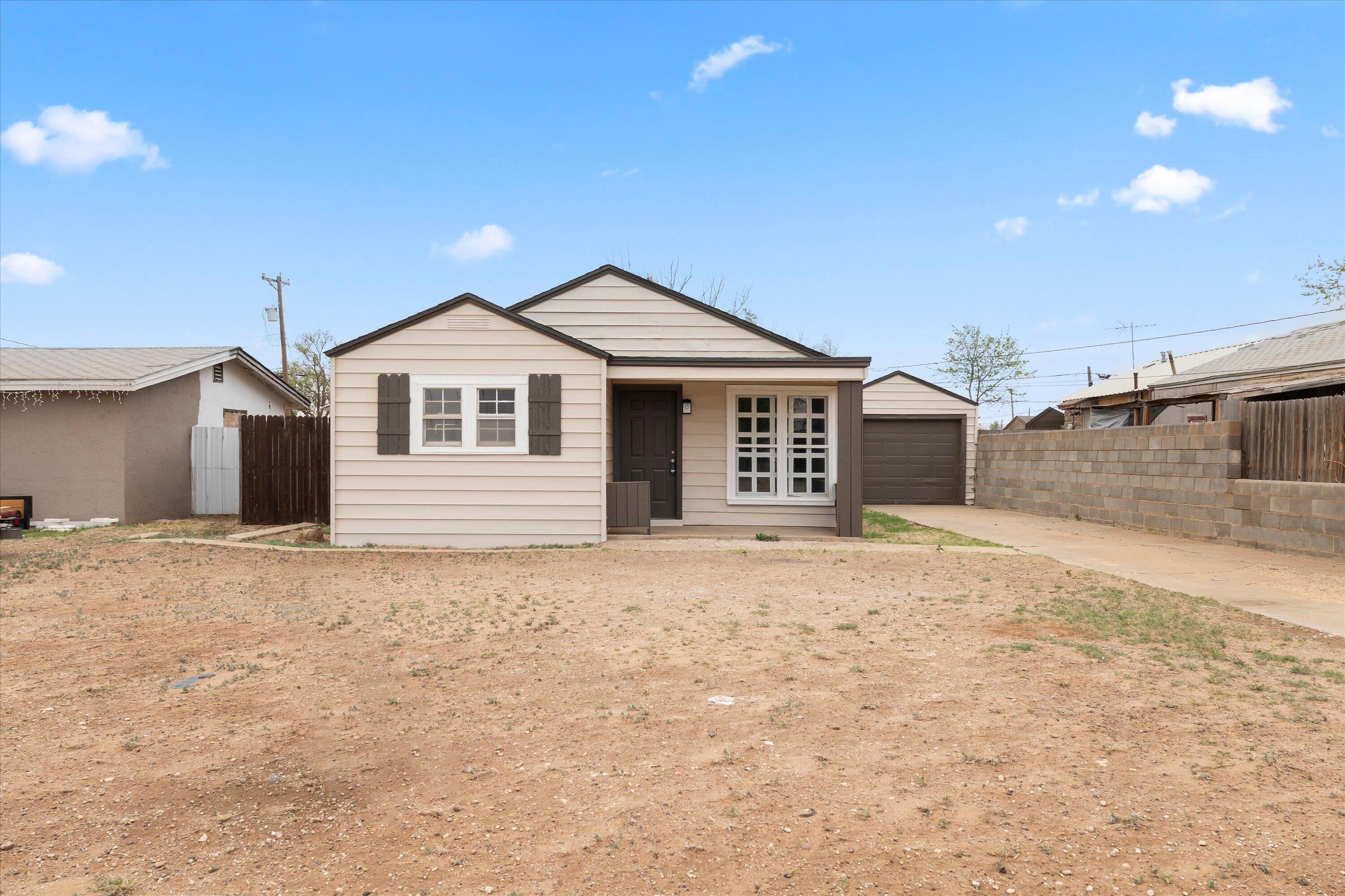204 Ave L Levelland, TX 79336 - Photo 1 of 27 a front door view of a house with a yard