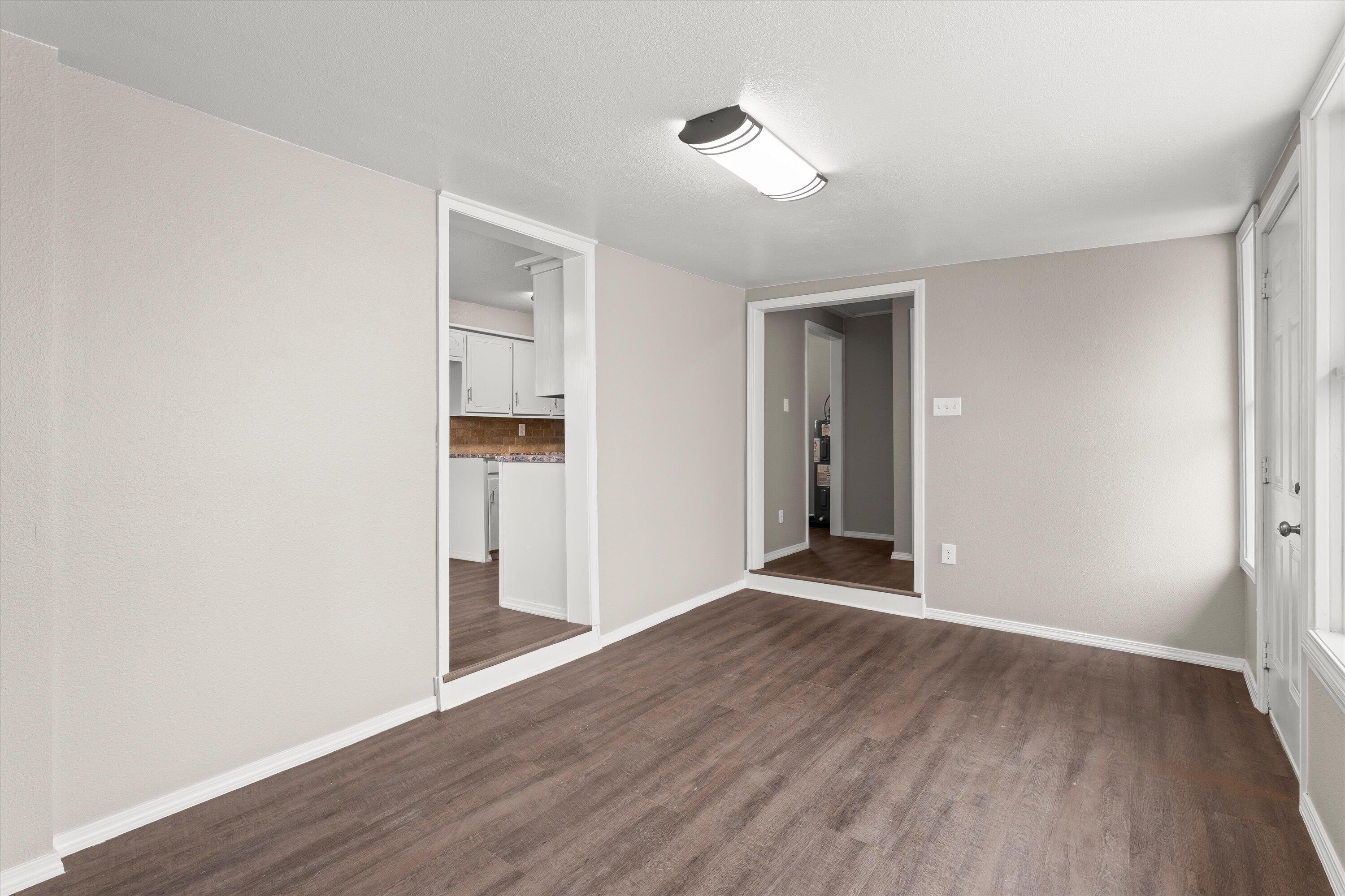 204 Ave L Levelland, TX 79336 - Photo 11 of 27 a view of an empty room with wooden floor