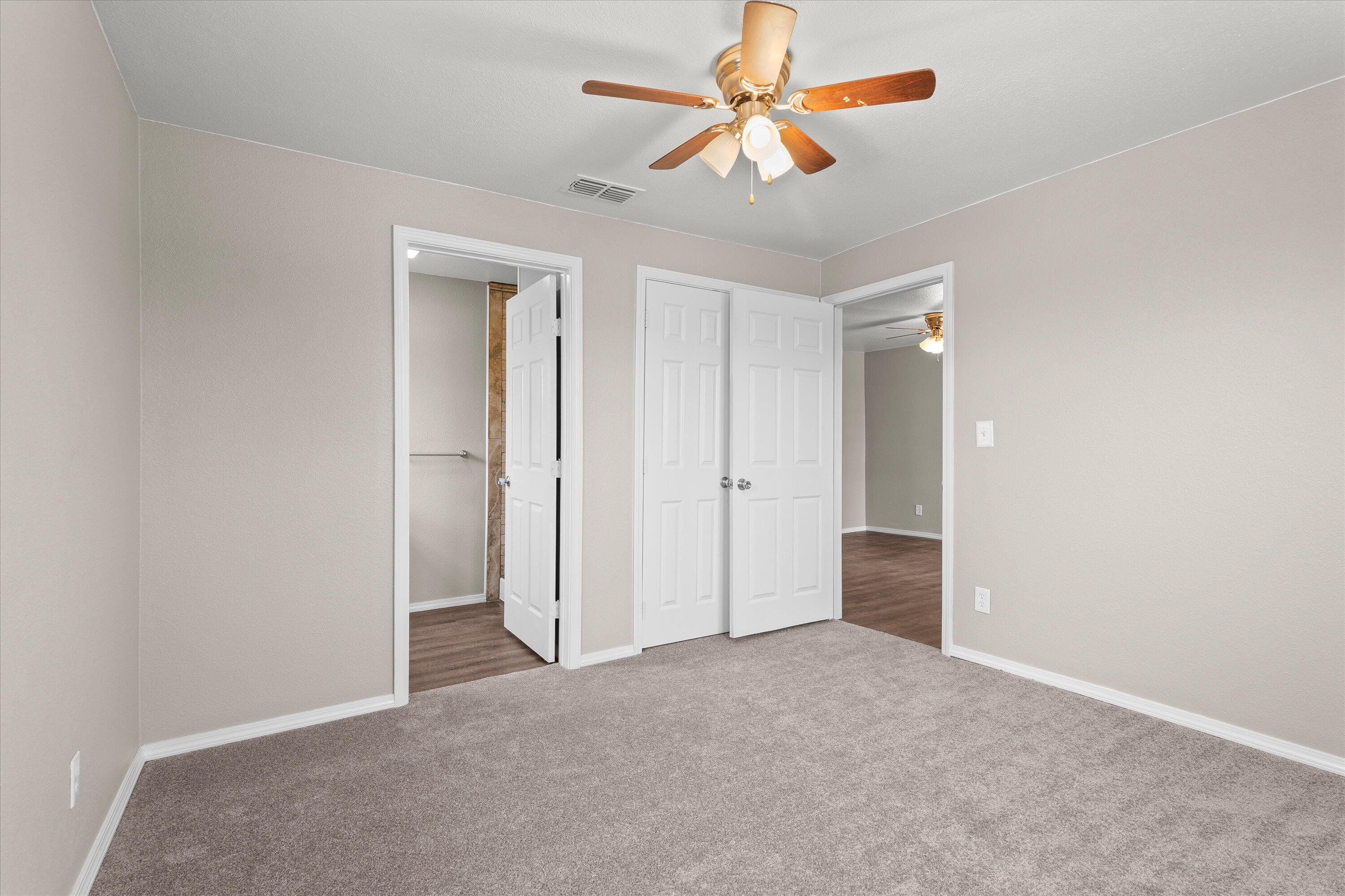 204 Ave L Levelland, TX 79336 - Photo 13 of 27 an empty room with closet and a chandelier fan