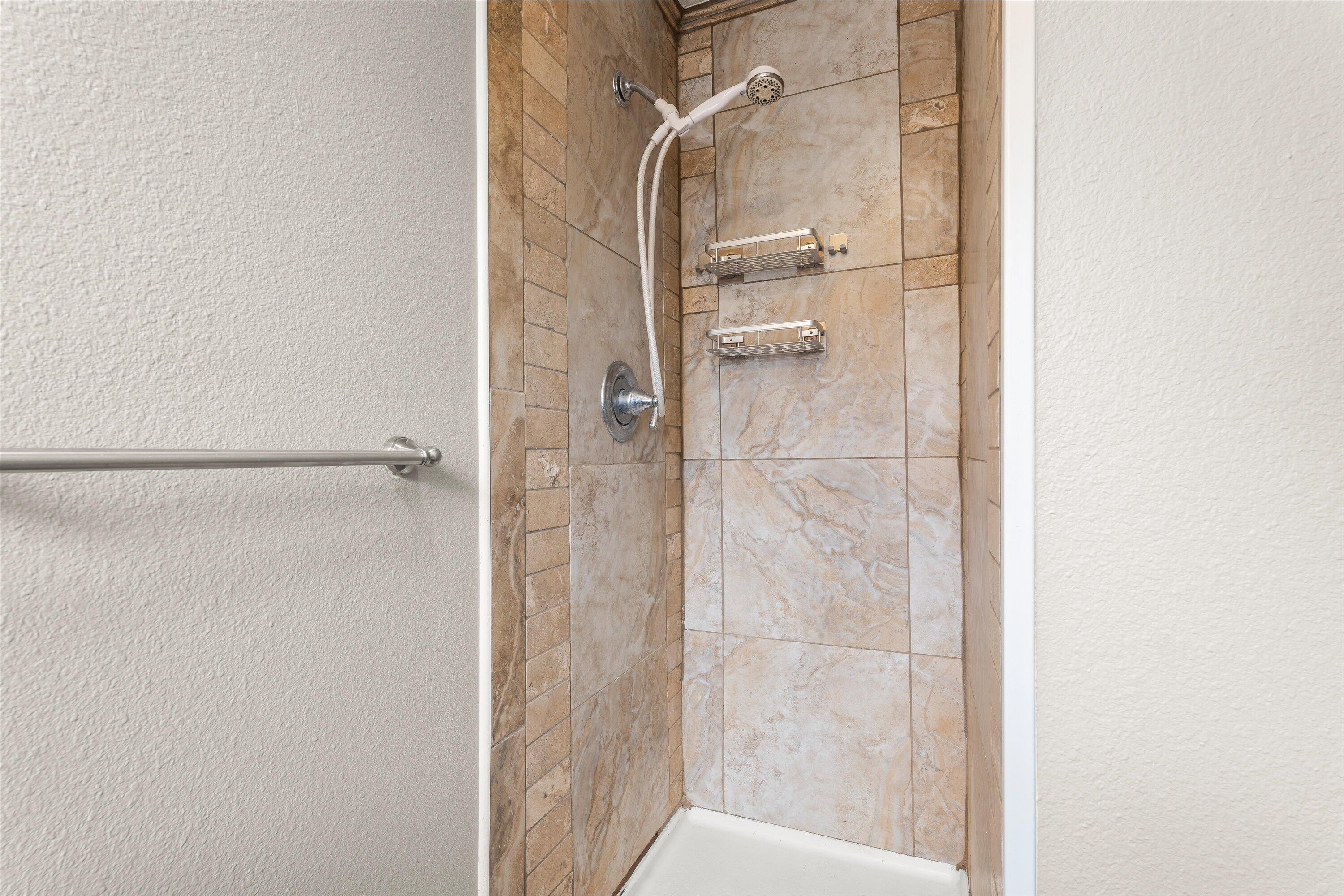 204 Ave L Levelland, TX 79336 - Photo 15 of 27 a bathroom with a glass shower door