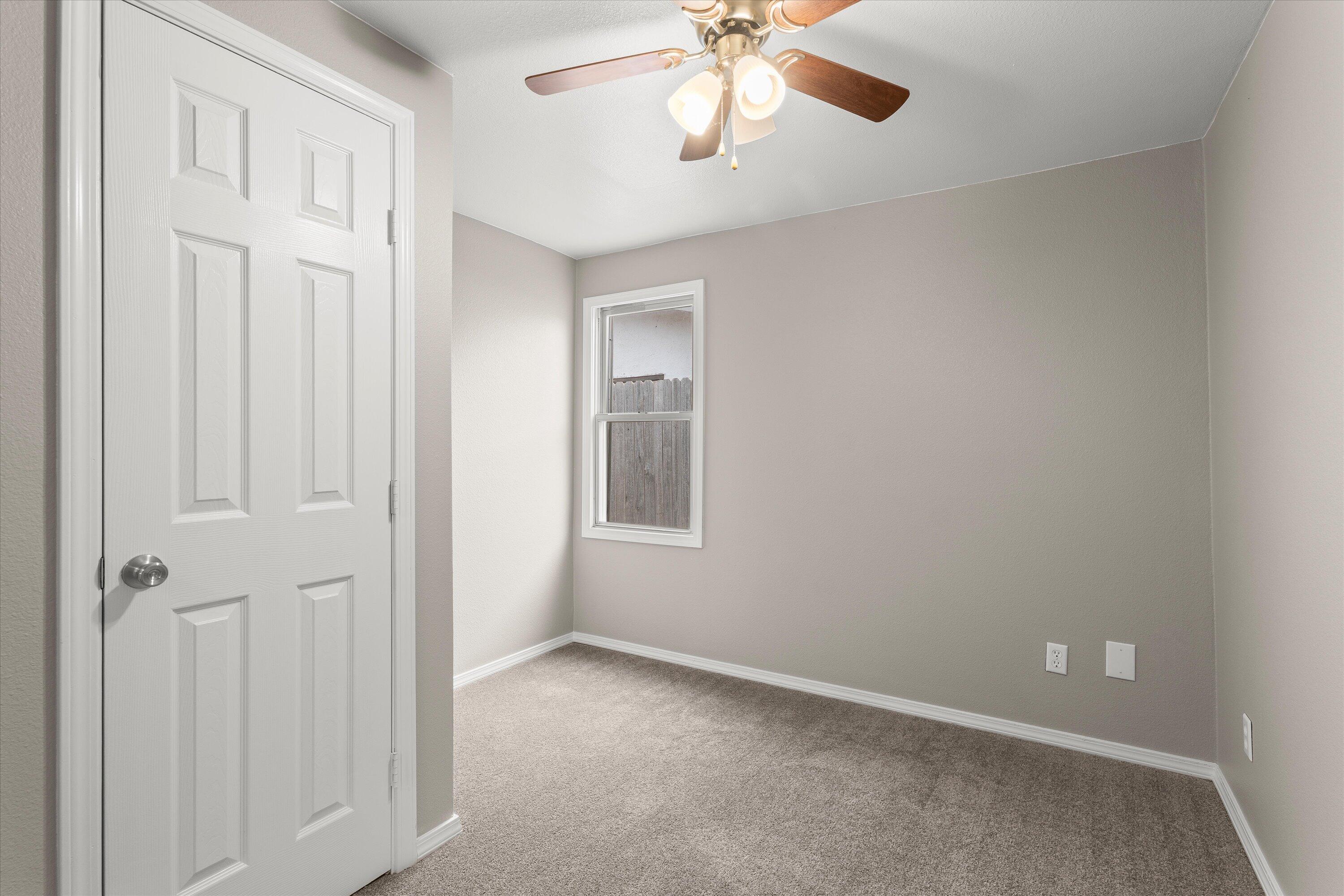 204 Ave L Levelland, TX 79336 - Photo 19 of 27 an empty room with windows and fan