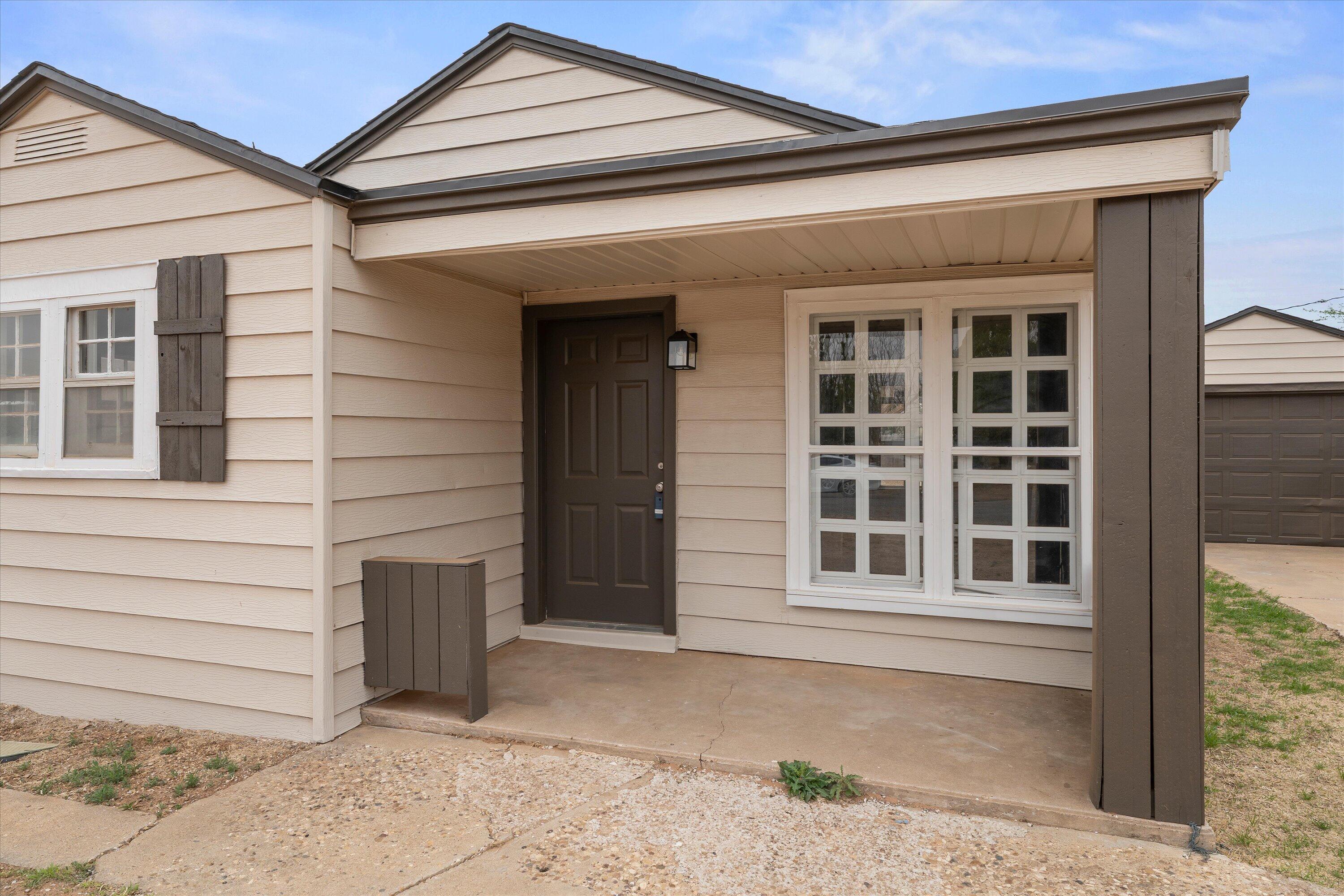204 Ave L Levelland, TX 79336 - Photo 2 of 27 a front view of a house with a window and brick walls
