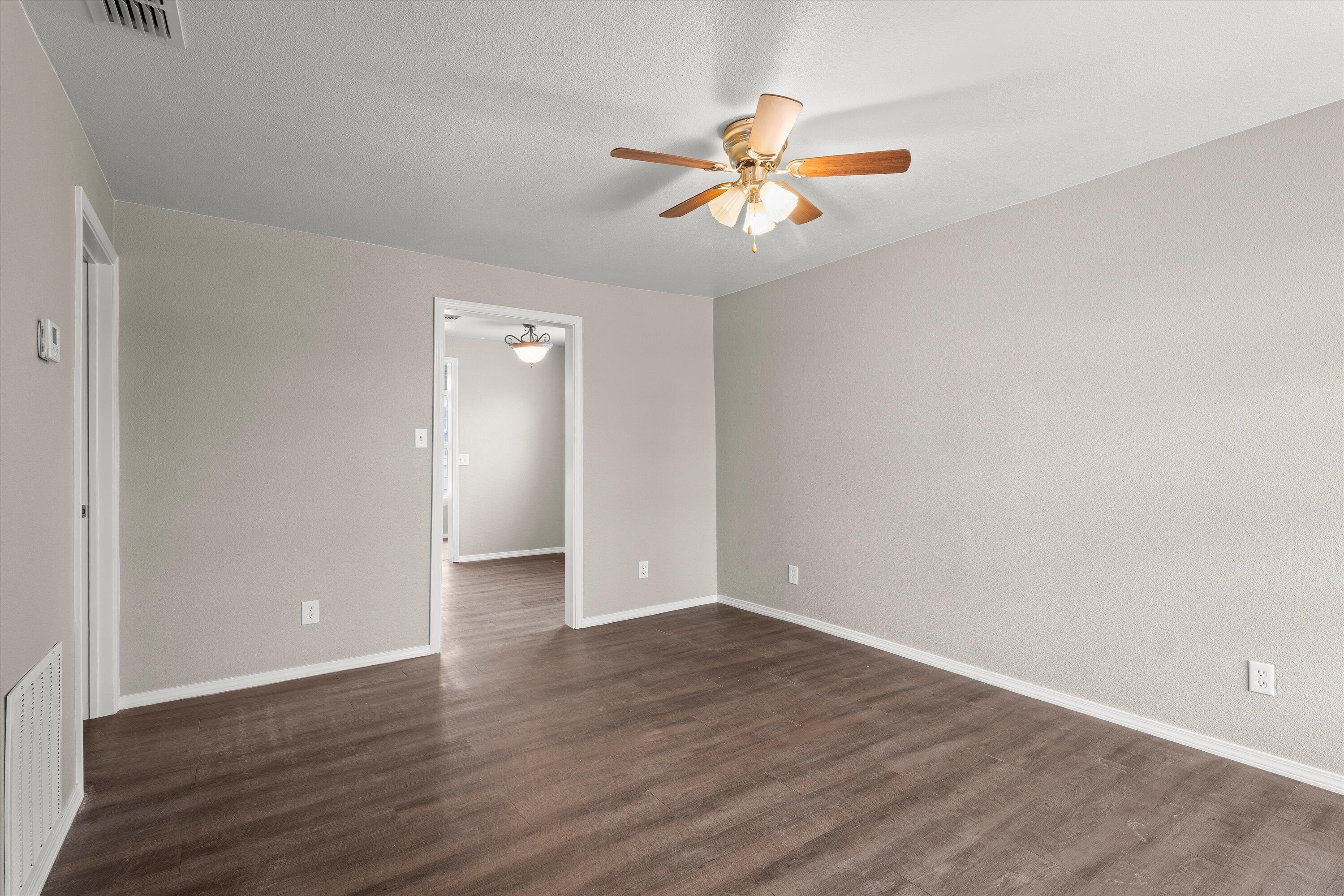 204 Ave L Levelland, TX 79336 - Photo 3 of 27 a view of an empty room with wooden floor