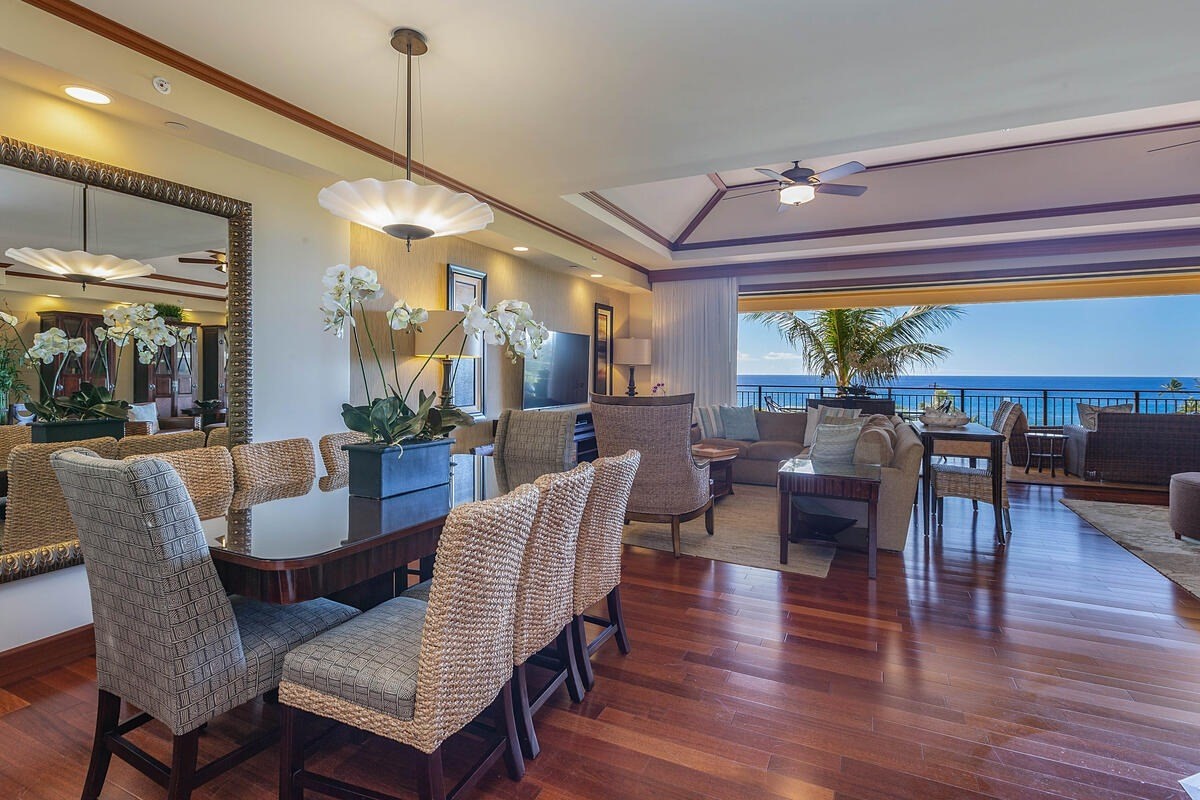 2641 Poipu Road, Unit 6401 Koloa, HI 96756 - Photo 6 of 30 a dining room with furniture a chandelier and wooden floor