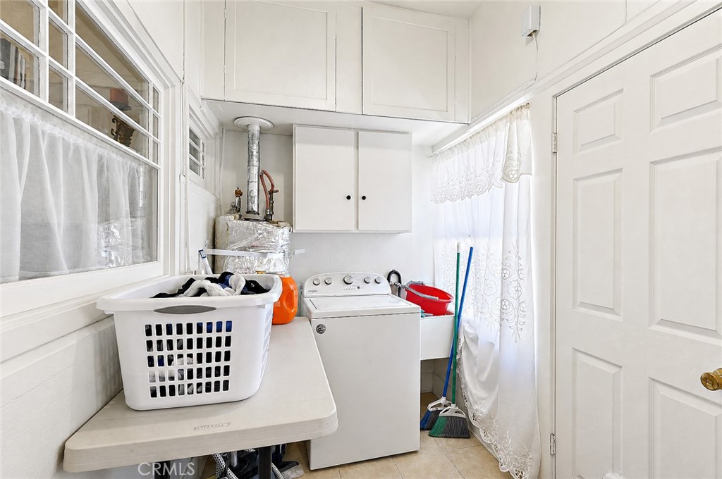 2130 Canal Street Merced, CA 95340 - Photo 16 of 45 a storage room with stainless steel appliances wooden floor window and cabinets