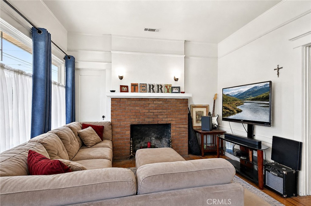 2130 Canal Street Merced, CA 95340 - Photo 10 of 45 a living room with furniture a flat screen tv and a fireplace