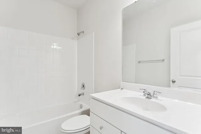 a bathroom with a sink a toilet and bathtub