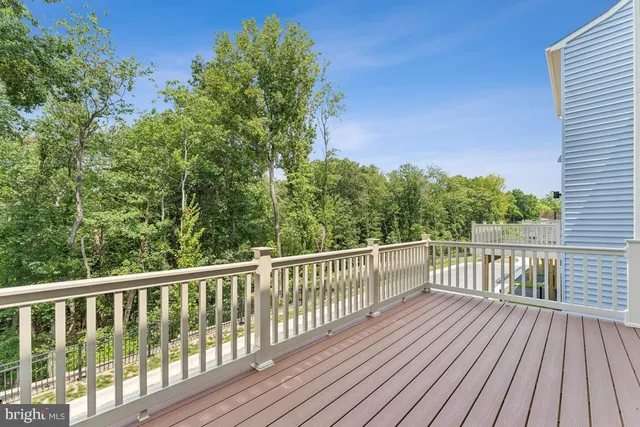 a view of balcony with wooden floor and fence