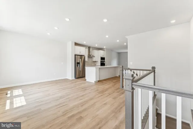 a view of kitchen with wooden floor and electronic appliances